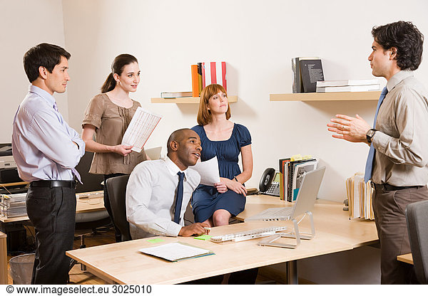 Five office workers in a meeting
