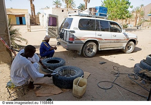 Fixing a flat tyre in the village of Dalgo. Upper Nubia  ash-Shamaliyah state  Sudan