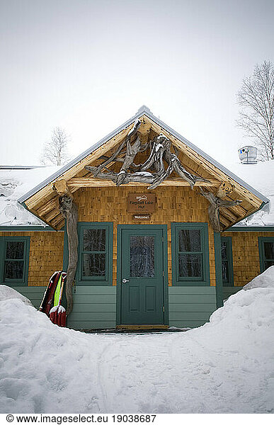 Flagstaff Hut covered in and surrounded by white  powdery snow at Maine Huts and Trails. Maine  New England.