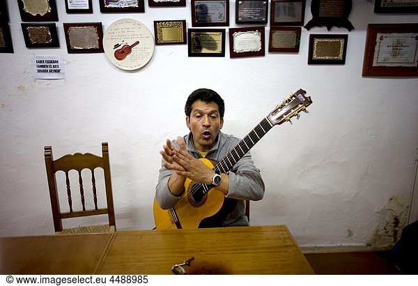 Flamenco singer and guitarrist Miguel Lain  known as Gitanillo de Ronda  sings and claps as he teaches some students in Ubrique  Cadiz province  Andalusia  Spain  May 13  2010