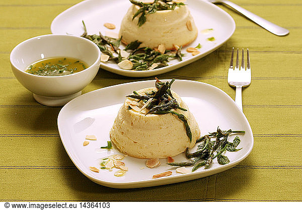 Flan made of Ricotta cheese with bruscandoli hop´s buds and toasted almond  Italy