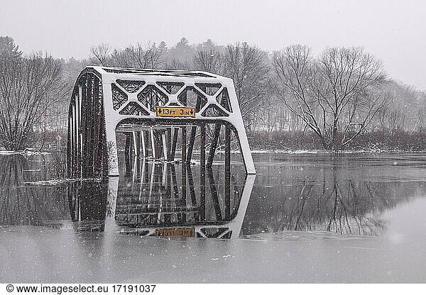 Flooded Bridge Reflected in Snowy Winter Scene