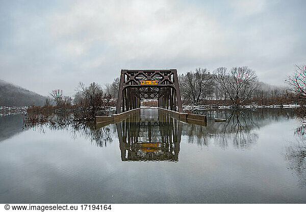 Flooded Bridge Reflected in Snowy Winter Scene