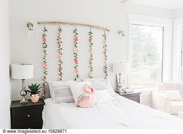 Floral garland hanging over bed