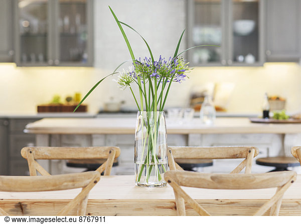 Flowers in vase on wooden table