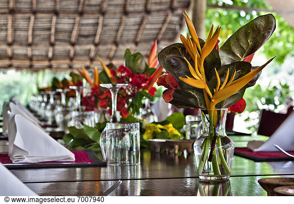 Flowers On Open Air Restaurant Dining Table