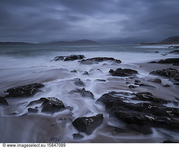 Flowing waves across small rocky beach  near Scarista  Isle of Harris  Scotland
