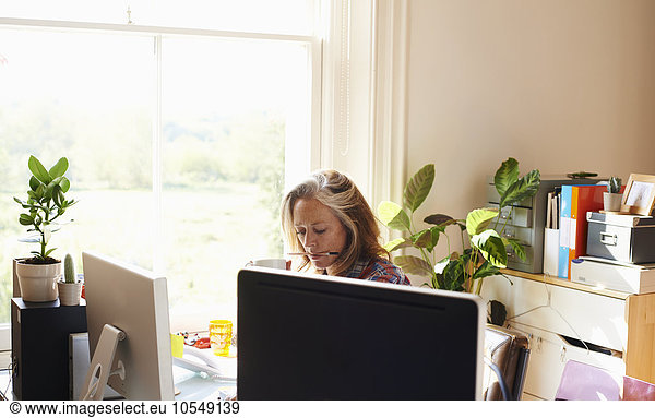 Focused woman working in home office