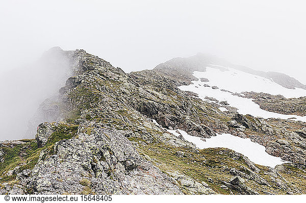 Fog and snow on rocky mountain ranges  Gmund  Tirol  Austria
