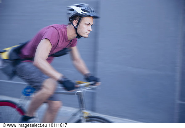 Fokussierter Fahrradkurier mit Helm unterwegs