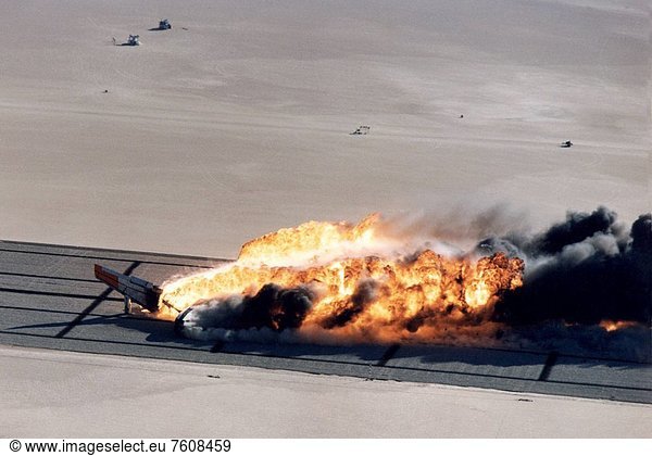 Following its controlled impact on posts imbedded in the lakebed  the B_720 is sliding sideways and almost enveloped in the large fireball with only the aircraft´s nose and right wing_tip exposed.