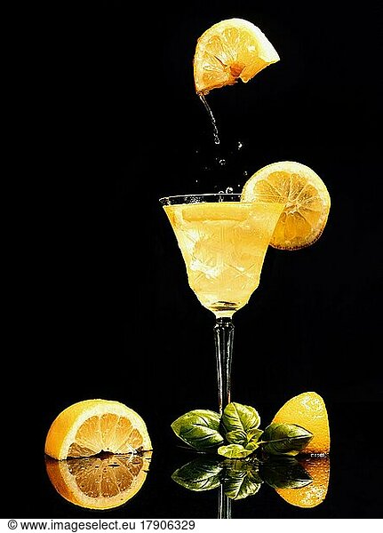 Food photography  lemon floating over glass with lemon juice  cocktail  black background