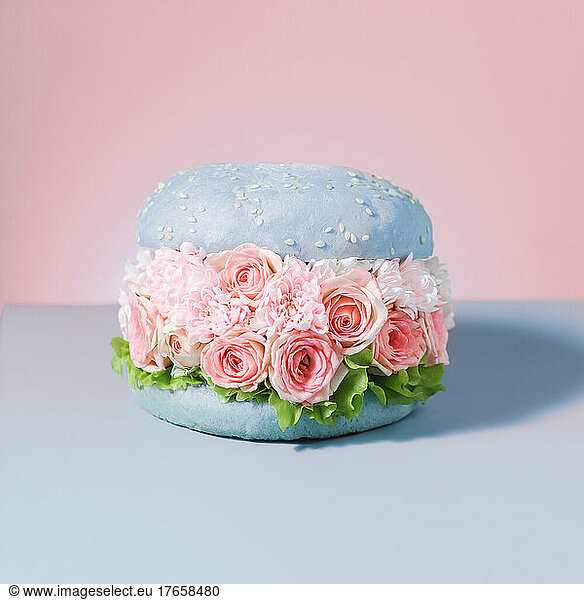 food vegan burgers with flowers on pink background