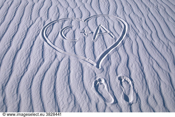 Foot prints and heart with letters in sand structures  White Sands national monument  New Mexico  USA