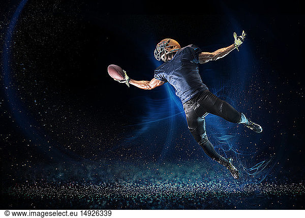 Football player reaching to catch football