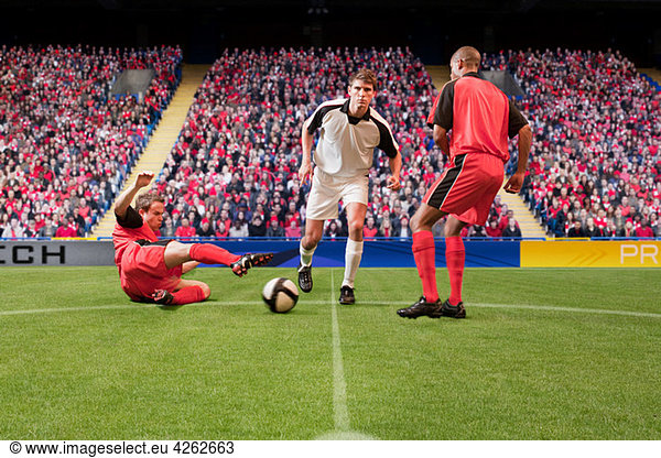 Football players kicking the ball