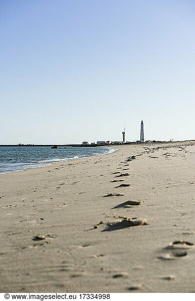 Footprint on beach during sunny day