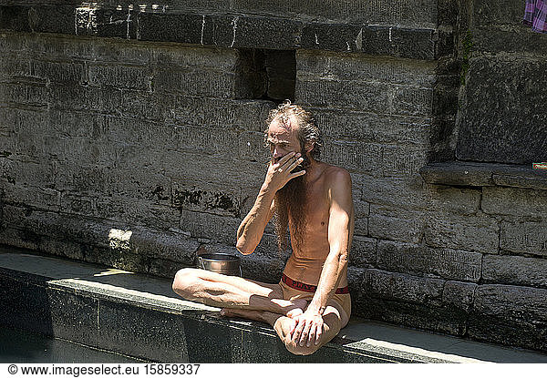 Foreigner Yogi with long beard sit at Vashisht Temple hot springs