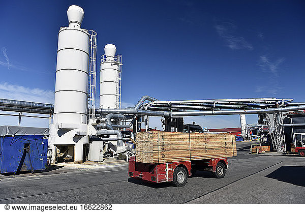 Forklift transporting planks in modern lumberyard