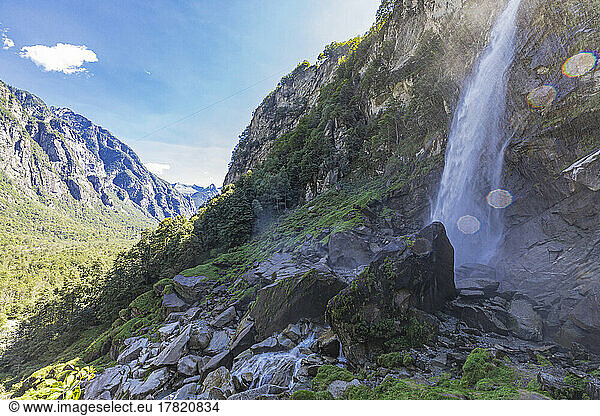 Foroglio waterfall splashing on rocks in valley