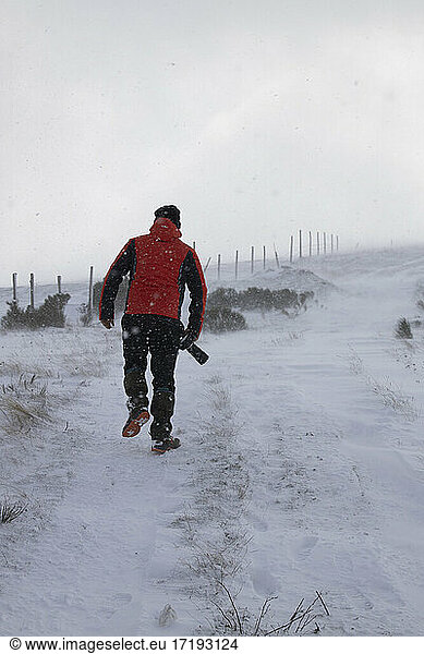 Fotograf bei einem Spaziergang mitten im Schneesturm