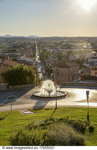 Fountain and town view from high on sunny day  Castiglione del Lago  Umbria  Italy