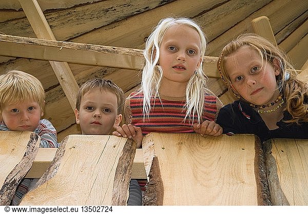 Four children looking down  portrait  Germany  Europe