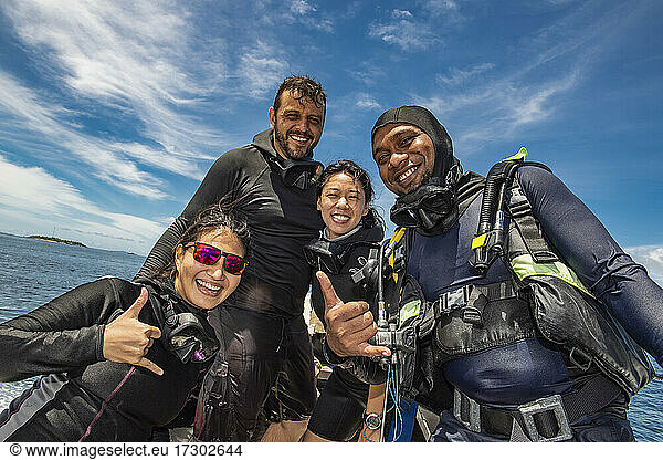 four friends after successful dive in Raja Ampat / Indonesia