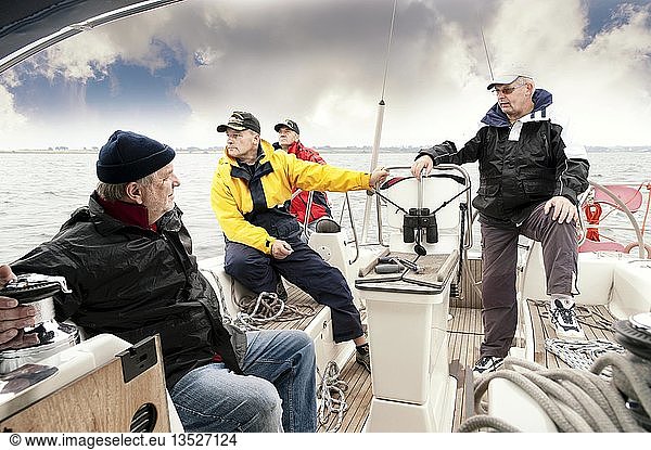 Four men on board a sailing yacht