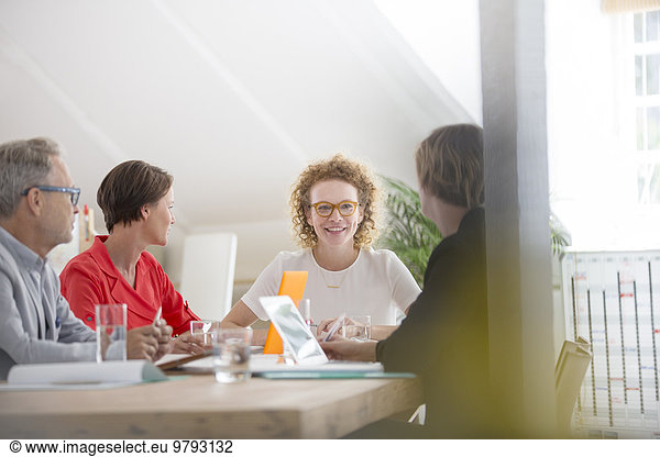 Four people at meeting in office