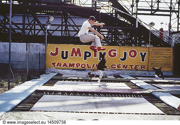 Four People on Amusement Park Trampolines  Coney Island  New York  USA  August 1961