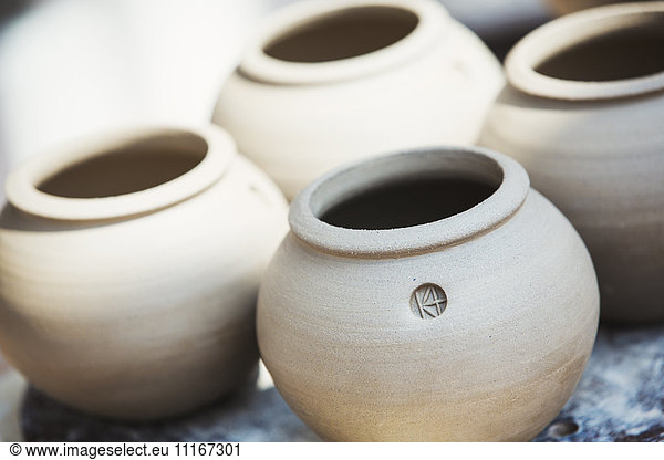 Four small round pots with round openings  vases of fresh turned clay.