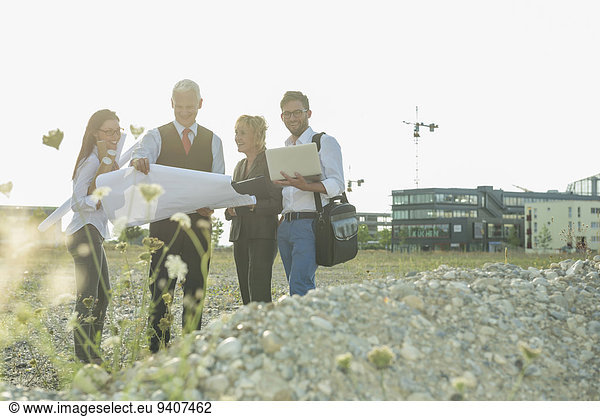 Four smiling people at development area