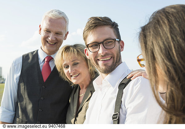 Four smiling people outdoors