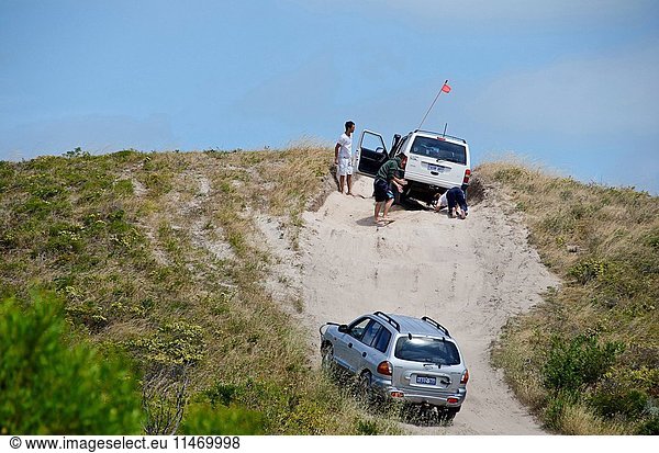 Four-wheel drive enthusiasts who have come to a halt in sand dunes  Two Rocks near Yanchep National Park  Western Australia  Australia. (Photo by: Auscape/UIG)