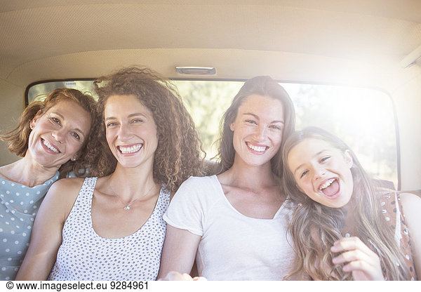 Four women sitting in backseat of car