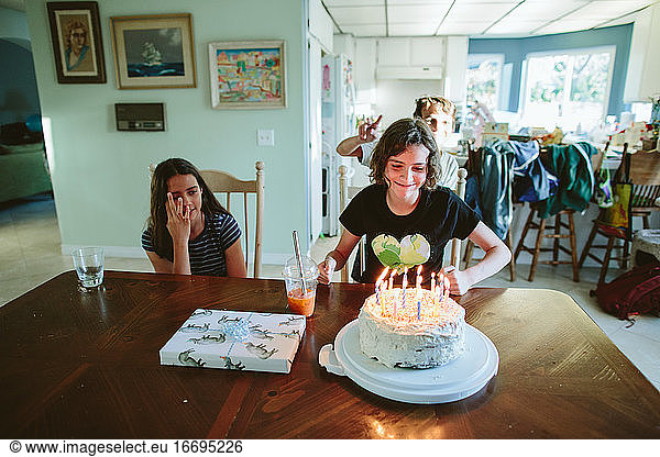 Fourteen year old girl prepares to blow out her birthday candles