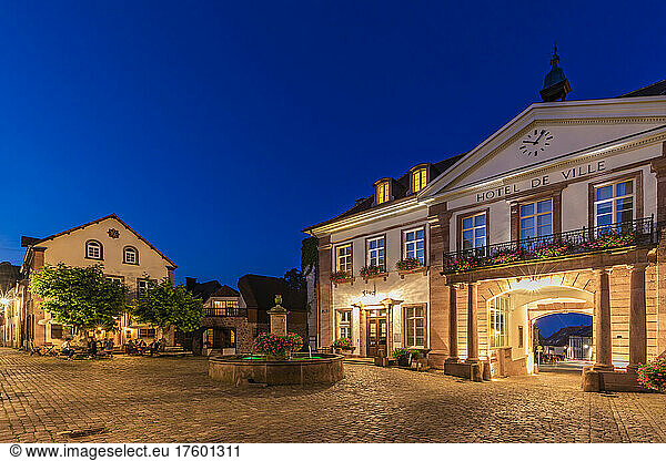 France  Alsace  Ribeauville  Empty town square and illuminated entrance of Hotel de ville at dusk