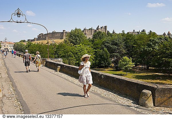 France  Aude  Carcassonne  Medieval city listed as World Heritage by UNESCO  woman walking on the Old Bridge which crosses the river Aude