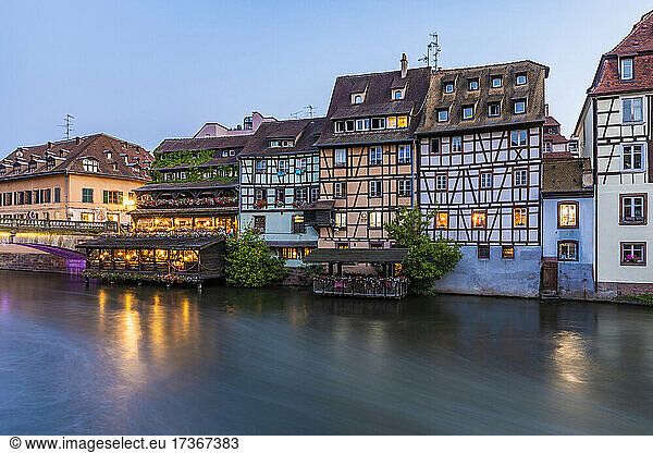 France  Bas-Rhin  Strasbourg  Townhouses along Ill River canal at dusk