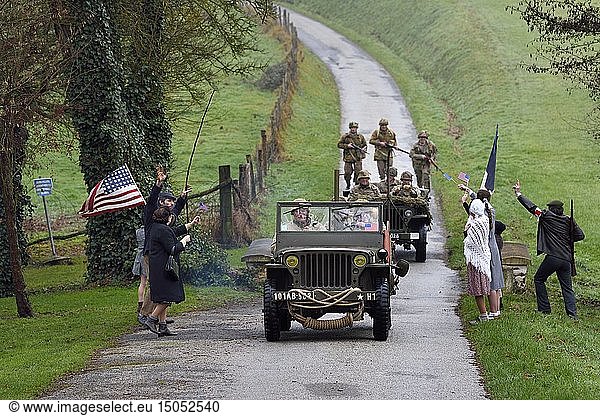 France  Eure  Sainte Colombe prés Vernon  Allied Reconstitution Group (US World War 2 and french Maquis historical reconstruction Association)  reenactors in uniform of the 101st US Airborne Division progressing in a jeep Willys welcomed as liberators by villagers and FFI