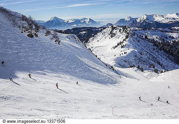 France  Haute Savoie  Morzine  the valley of Aulps  massif of Chablais  ski slopes of the Portes du Soleil  red ski slope of Arbis of the sector of Chamossiere with a view of the valley of Arve