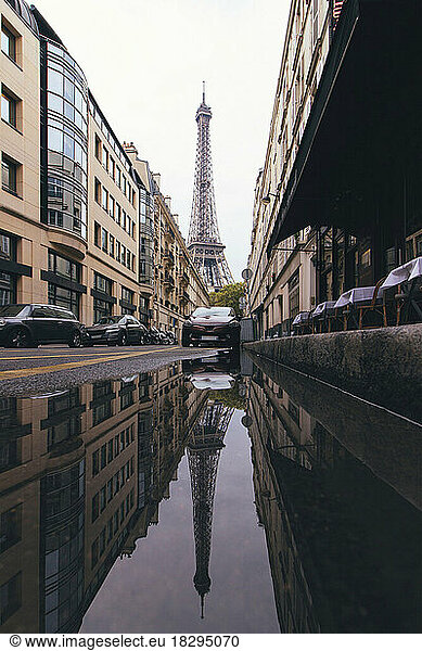 France  Ile-de-France  Paris  Eiffel Tower reflecting in street puddle