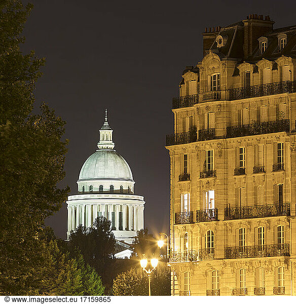 France  Ile-de-France  Paris  Illuminated dome of Pantheon at night with residential building in foreground