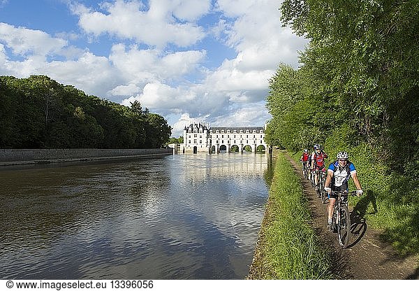 France  Indre et Loire  Loire Castles  Chenonceaux  Chenonceau castle in Renaissance style across the Cher river and cyclists