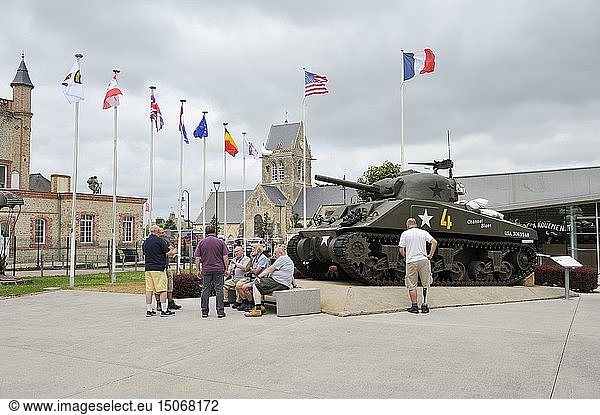 France  Manche  Sainte Mere Eglise  Utah Beach  Airborne Museum  tourists in front of the American Sherman tank and bell tower of the church