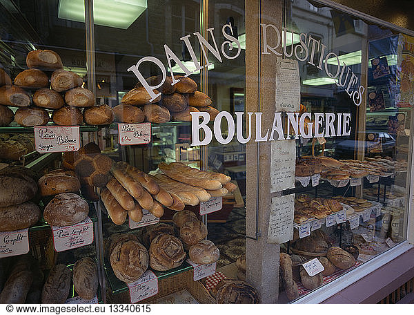 FRANCE Nord-Picardy Pas-de-Calais. Boulogne. Boulangerie in Haute Ville  part view of exterior with window filled with breads and cakes.