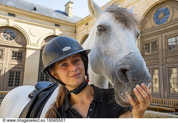 France  Oise  Chantilly  Chantilly Castle  the Great Stables  moment of intimacy between a horsewoman and her horse