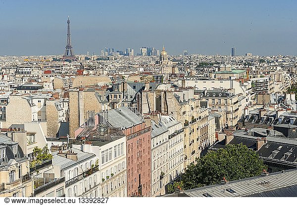 France  Paris  Emerging amid the rooftops of Paris  the Eiffel Tower  In the background  the gilded dome of Les Invalides In the distance  La Defense (aerial view)