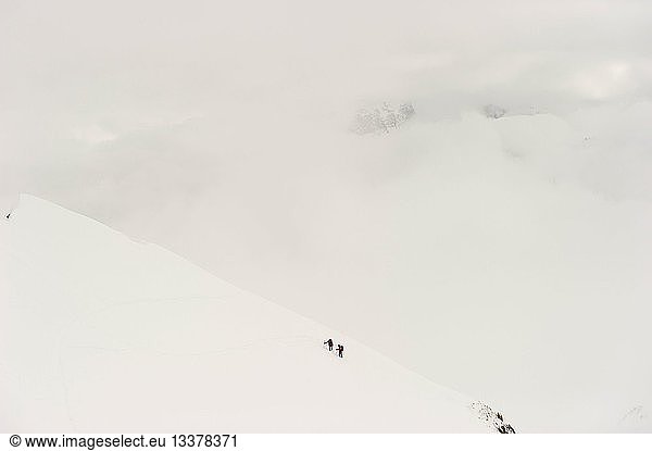 France  Savoie  Tarentaise and Vanoise  Tignes  off piste skiers moving in the fog above Tignes